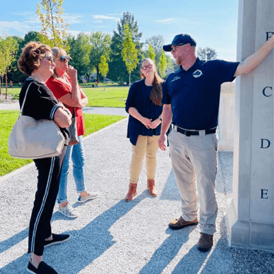 Tour Guide Explaining an Exhibit to Visitors